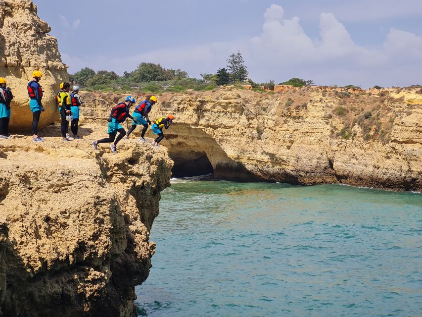 Albufeira: Guided Coasteering Tour with Cliff Jumping - Swimming through caves and climbing the cliffs