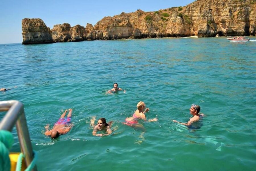 From Lagos: 2.5-Hour Guided Coastal Boat Tour & Grotto Visit - The aqua trampoline is the playful extra
