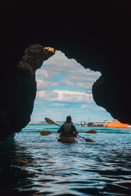 From Lagos: Ponta da Piedade Caves Kayak Tour from Catamaran - Sliding from the catamaran into your kayak