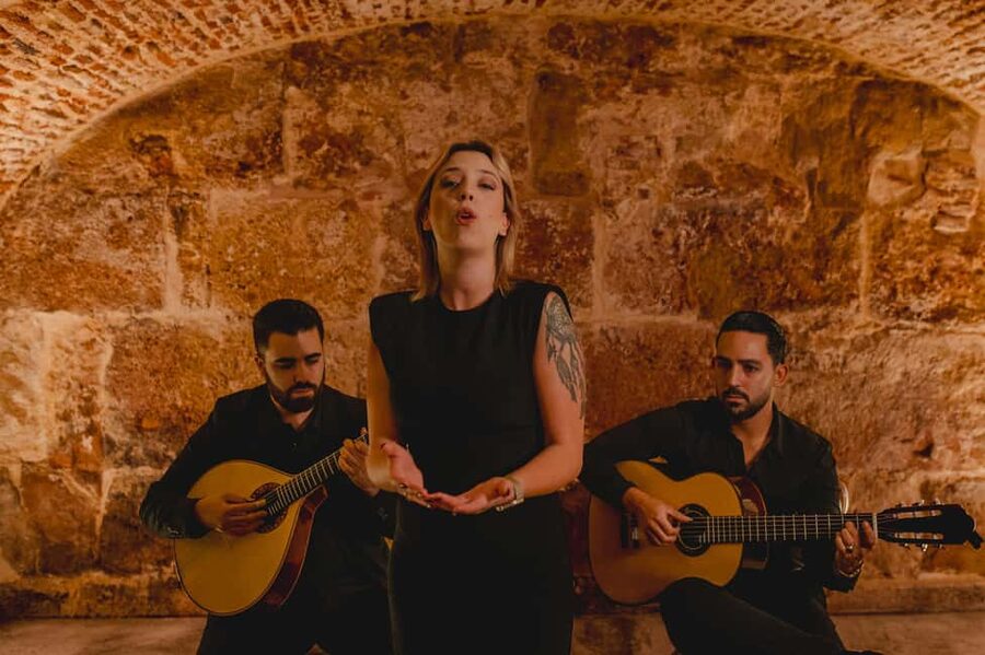 Lisbon: Fado Show with Wine in a Historic Venue - Entering through the blue doors near Sé Cathedral