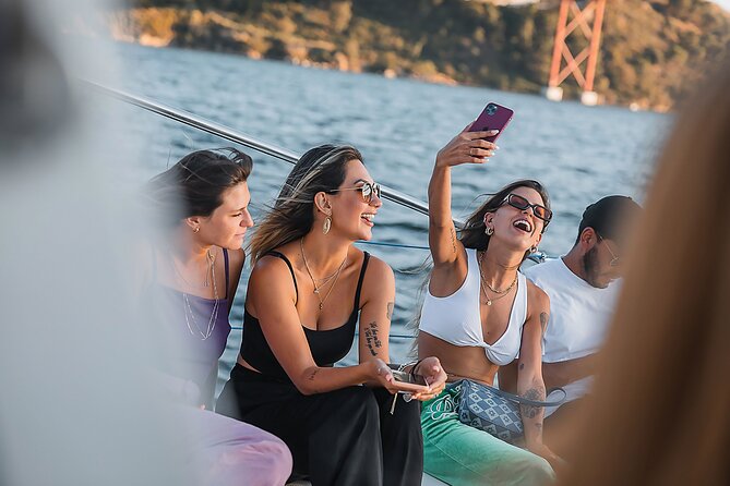 Lisbon: Sunset Catamaran Boat Tour with Music and Drinks - Passing beneath the 25th of April Bridge