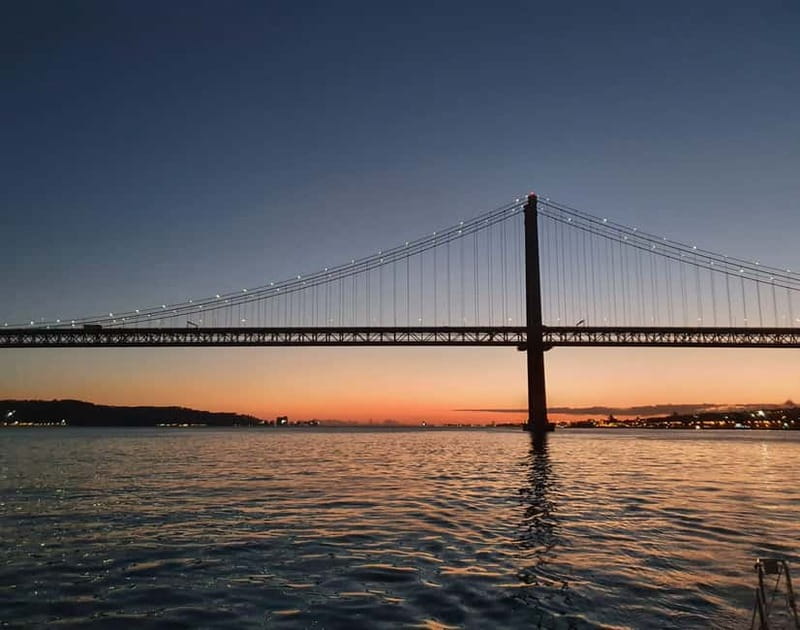 Lisbon: Sunset Sailing Boat Tour with Drinks - The 25th of April Bridge at sunset